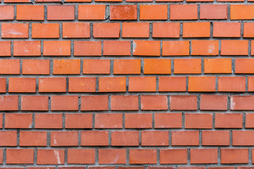 Obraz premium Closeup view of red brick well-built wall background.