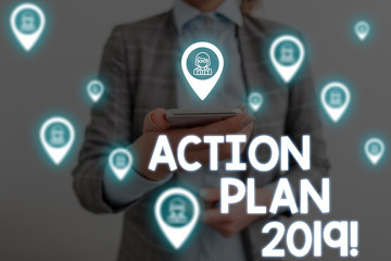 Handwriting text writing Action Plan 2019. Conceptual photo proposed strategy or course of actions for current year Woman wear formal work suit presenting presentation using smart device