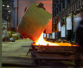 Pouring molten glass into mold in the glass factory