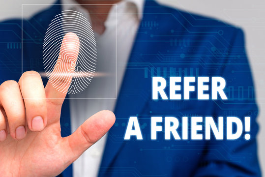 Conceptual hand writing showing Refer A Friend. Concept meaning direct someone to another or send him something like gift Male wear formal work suit presenting presentation smart device