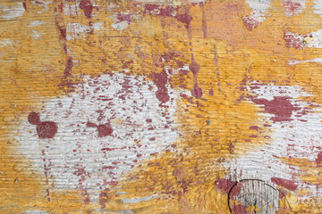 Old gray-brown natural wood background in the form of a board with cracks, knots and a rough surface