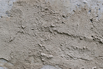 Old gray concrete wall with yellow and brown spots as an abstract background