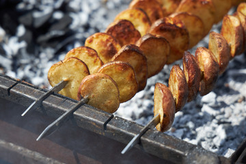 Appetizing potatoes with a crispy golden crust are grilled