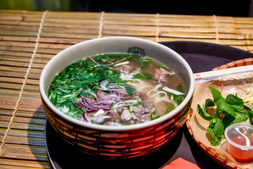 Traditional Vietnamese soup, Pho Bo in a large bowl.