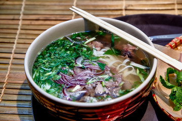 Traditional Vietnamese soup, Pho Bo in a large bowl.