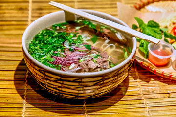 Traditional Vietnamese soup, Pho Bo in a large bowl.