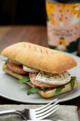 Grilled caprese ciabatta with tomatoes, pasta sauce and mozzarella, served with a cup of coffee