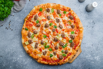 Mexican pizza with meat and jalapeno on beautiful grey table