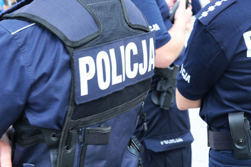 Katowice, Poland-august/15/2019 The policeman on the street on duty. Close up of police logo.