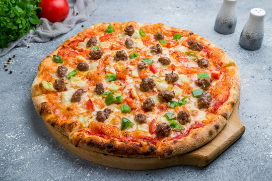 Mexican pizza with meat and jalapeno on beautiful grey table