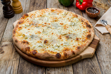 Pizza Quattro formaggi on old wooden table