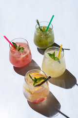 Assortment of refreshing summer lemonades: classic lemon soda, strawberry lemonade, ginger spicy...