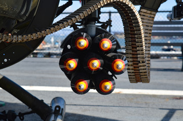 Head-on shot of colorful missiles attached to a grounded aircraft