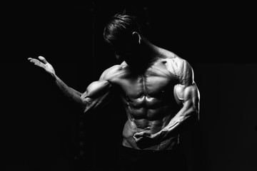 Obraz na płótnie Canvas Bodybuilder Flexing Muscles