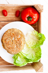 quinoa vegetable burger with quinoa bowl, tomato 