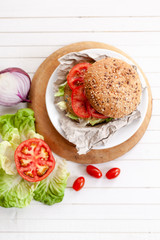 quinoa vegetable burger with tomato and onion