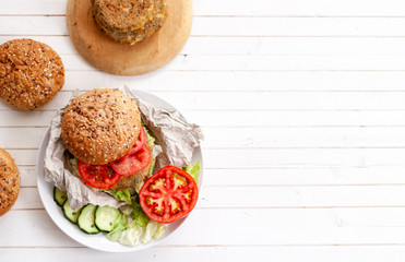 quinoa vegetable burger with tomato and onion