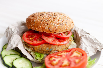 quinoa vegetable burger with quinoa bowl, tomato and onion