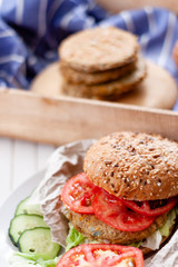 quinoa vegetable burger with quinoa bowl, tomato and onion