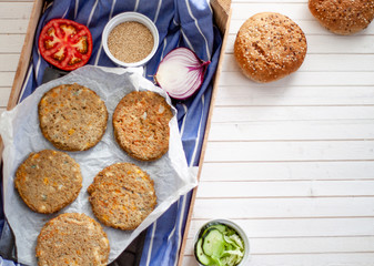 quinoa vegetable burger with quinoa bowl, tomato and onion