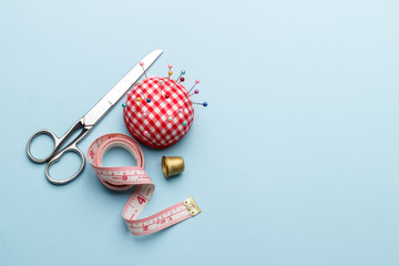 Sewing items on blue background