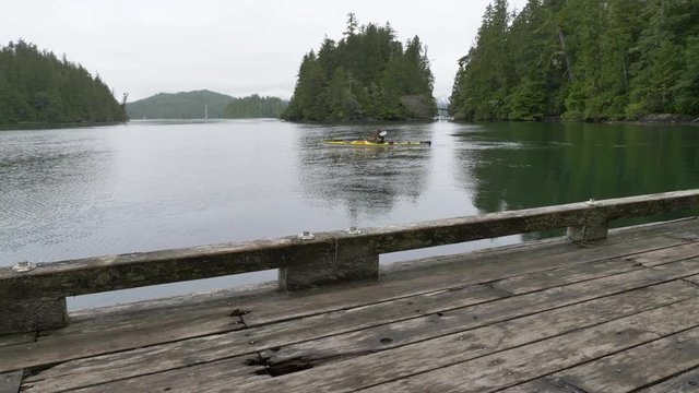 Kayaker paddles around Meares Island, British Columbia
