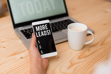 Word writing text More Leads. Business photo showcasing initiation consumer interest enquiry into products or services woman laptop computer smartphone mug office supplies technological devices
