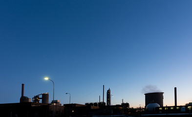 Industrial plant at night with deep blue sky