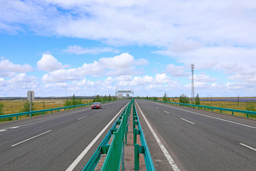 Beautiful highway, under the blue sky and white clouds