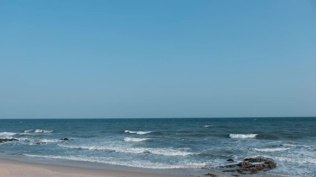 Stock 4k: Beautiful beach background with sea, waves, horizon and blue sky. Royalty high-quality free stock video footage of nobody on the beach. The sea is a great place to visit in the summer