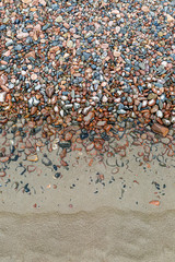 Looking down on pebbles and sand on a Jersey beach