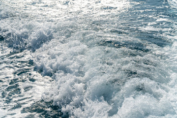 Closeup of wave traces on the blue ocean surface with copy space