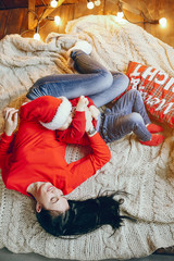 Cute family have fun in decorating room. Beautiful mother with little son. Family in a red sweaters