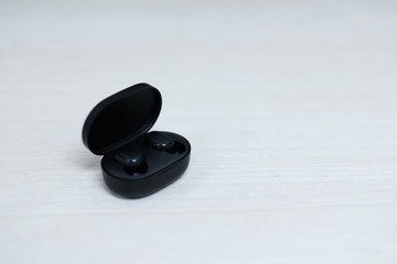 Black wireless bluetooth headphones on the table