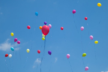 multicolored balls launched in the blue sky