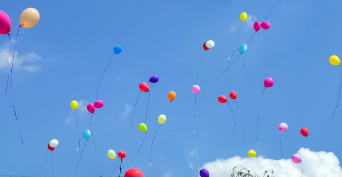 multicolored balls launched in the blue sky