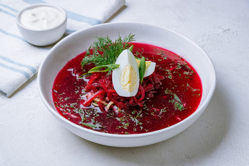 beetroot soup on bowl on white concrete table