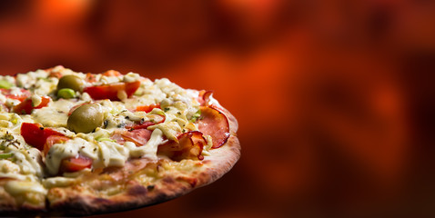 Pizza isolated in an out of focus wooden fire background