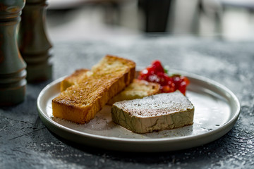 The chicken liver pate with bread and jam on dark grey concrete table