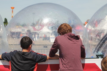 Boys and big plastic bubble balls