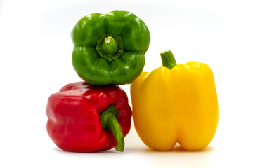 Stack of three color bell pepper on white background.