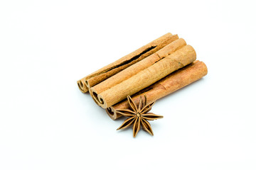 Closed up of anise and cinnamon sticks on white isolated background.