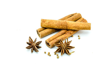 Closed up of anise and cinnamon sticks on white isolated background.