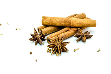 Closed up of anise and cinnamon sticks on white isolated background.