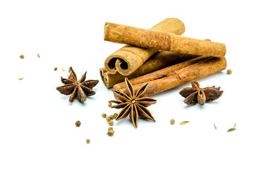 Closed up of anise and cinnamon sticks on white isolated background.