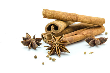 Closed up of anise and cinnamon sticks on white isolated background.