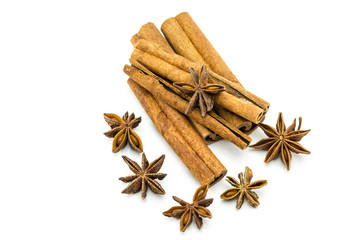 Closed up of anise and cinnamon sticks on white isolated background.