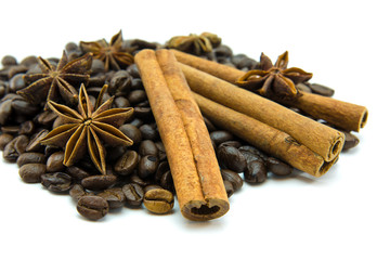 Closed up of coffee beans, anise and cinnamon sticks on white isolated background.