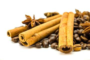 Closed up of coffee beans, anise and cinnamon sticks on white isolated background.