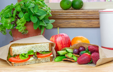 Packed lunch using authentic homemade sandwich and fresh foods packed in recyclable paper sandwich bags, plastic free alternative to single use plastic, ready to pack for school, work or play 